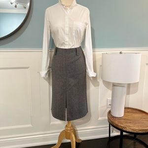 Tailored skirt with front split and designer details